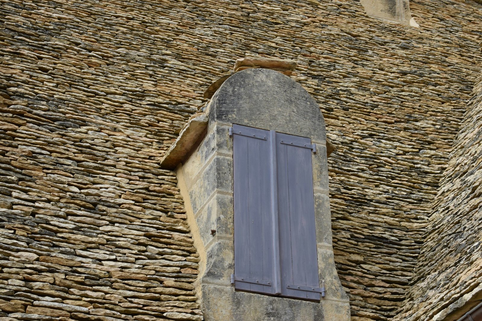 low-angle photography of closed gray wooden window